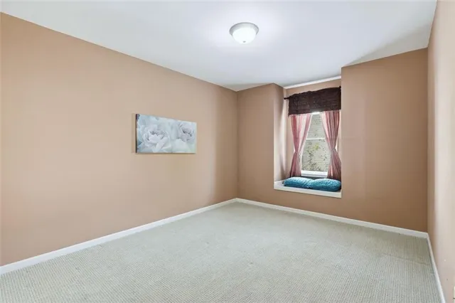 a kitchen with granite countertop a sink a stove cabinets and a sink