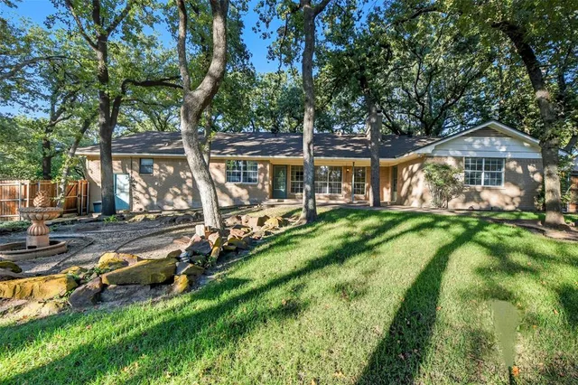 an aerial view of a house with swimming pool and patio