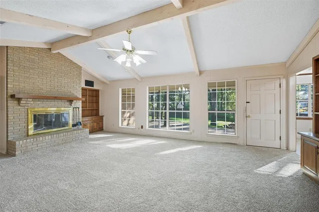 a view of an empty room with a fireplace