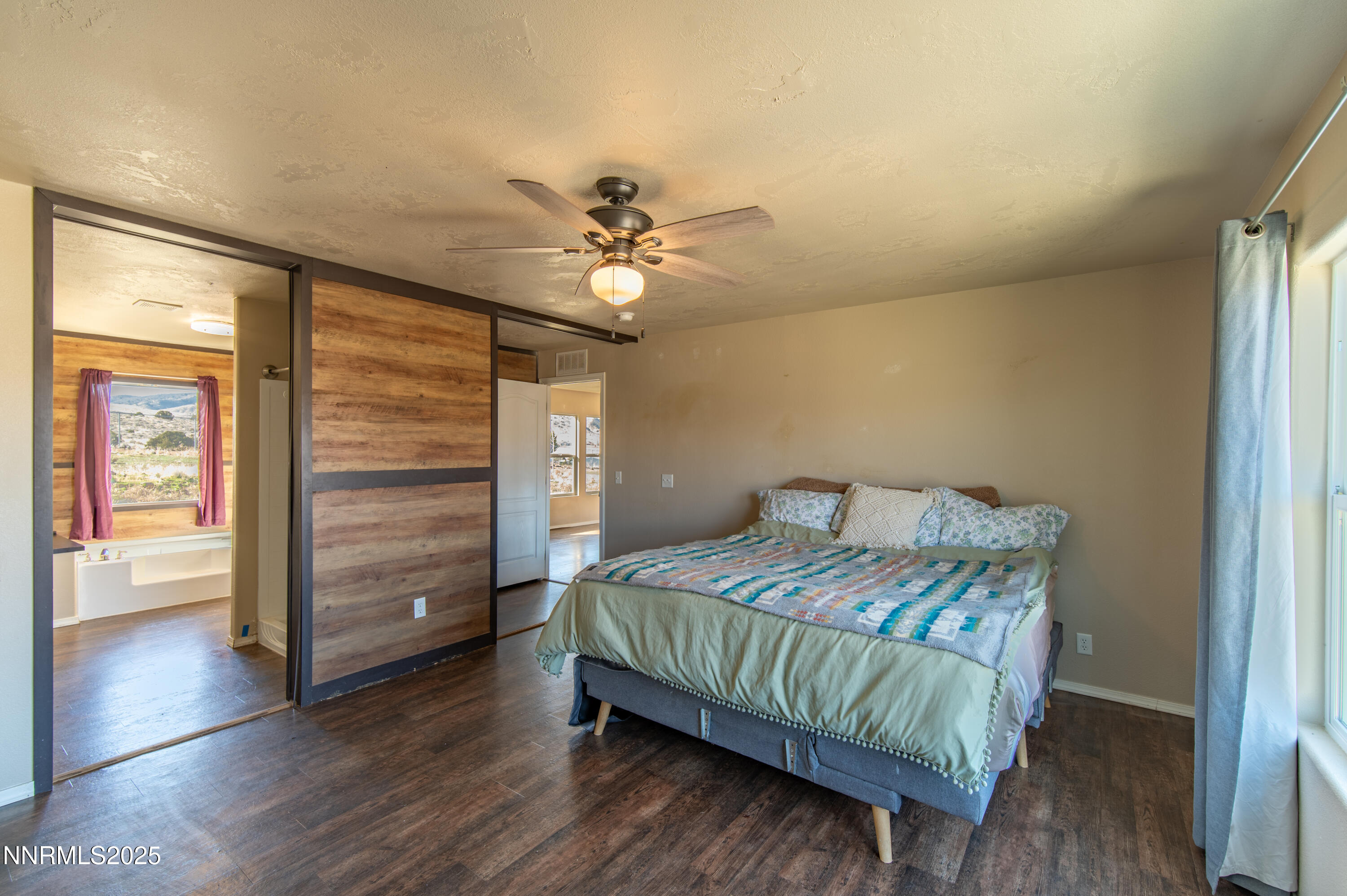 3900 Morning Dove Road Reno, NV 89510 - Photo 12 of 27 a bedroom with a bed and a ceiling fan