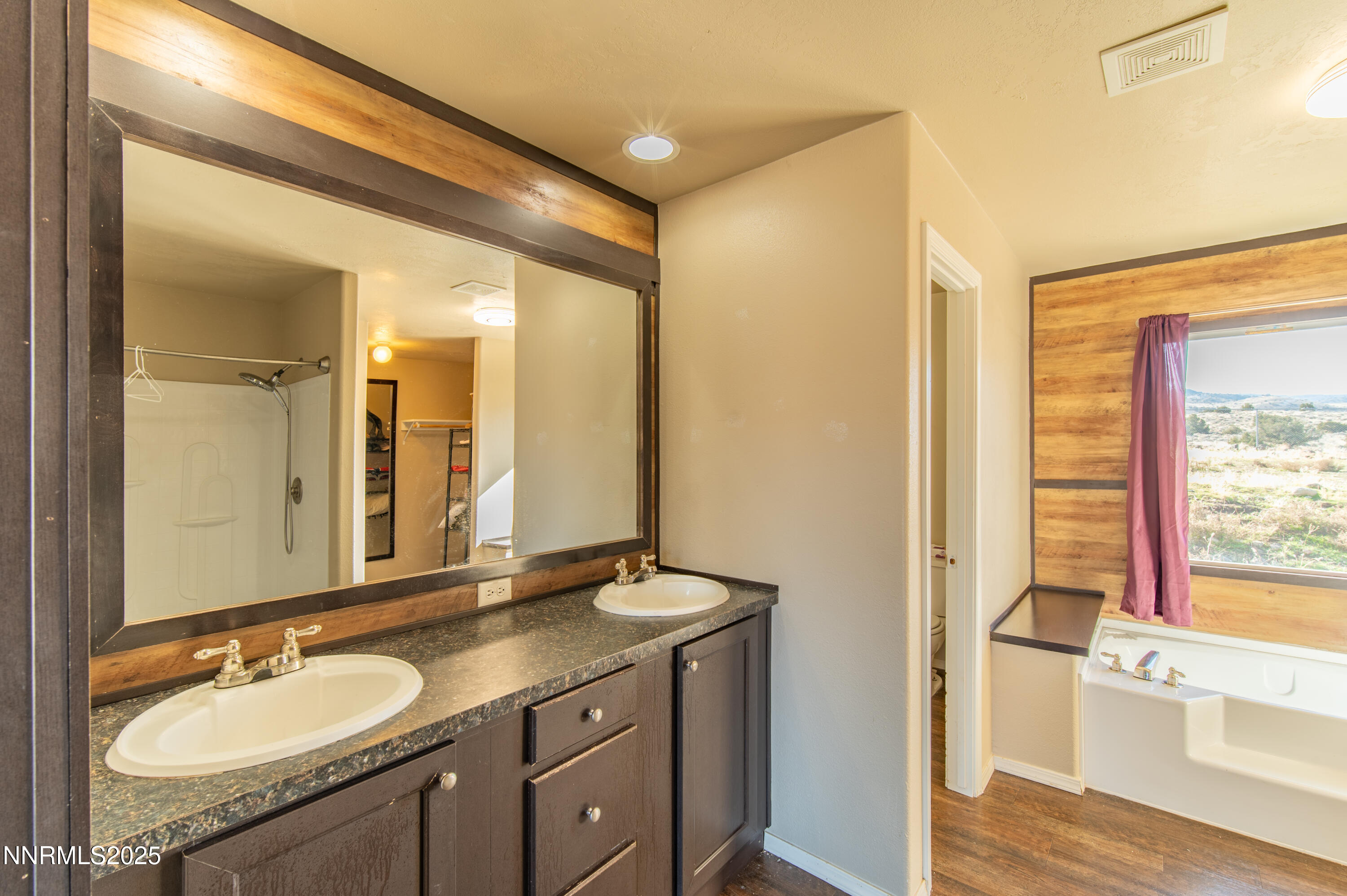 3900 Morning Dove Road Reno, NV 89510 - Photo 14 of 27 a bathroom with a granite countertop sink a mirror and a shower