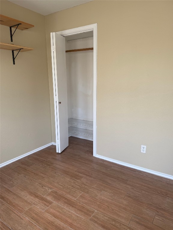 1808 Rio Grande Street, Unit 3 Austin, TX 78701 - Photo 11 of 29 a view of an empty room with wooden floor and a window