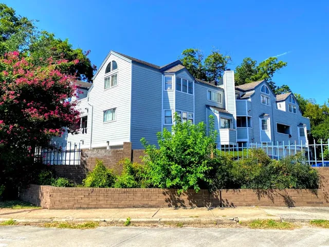 a house with a big yard and large trees