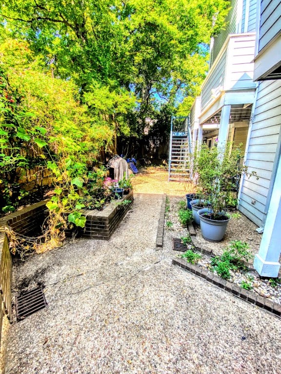 1808 Rio Grande Street, Unit 3 Austin, TX 78701 - Photo 24 of 29 a view of a backyard with plants and a garden