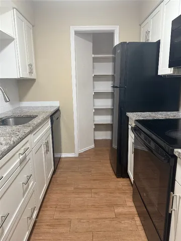 a view of hallway with wooden floor