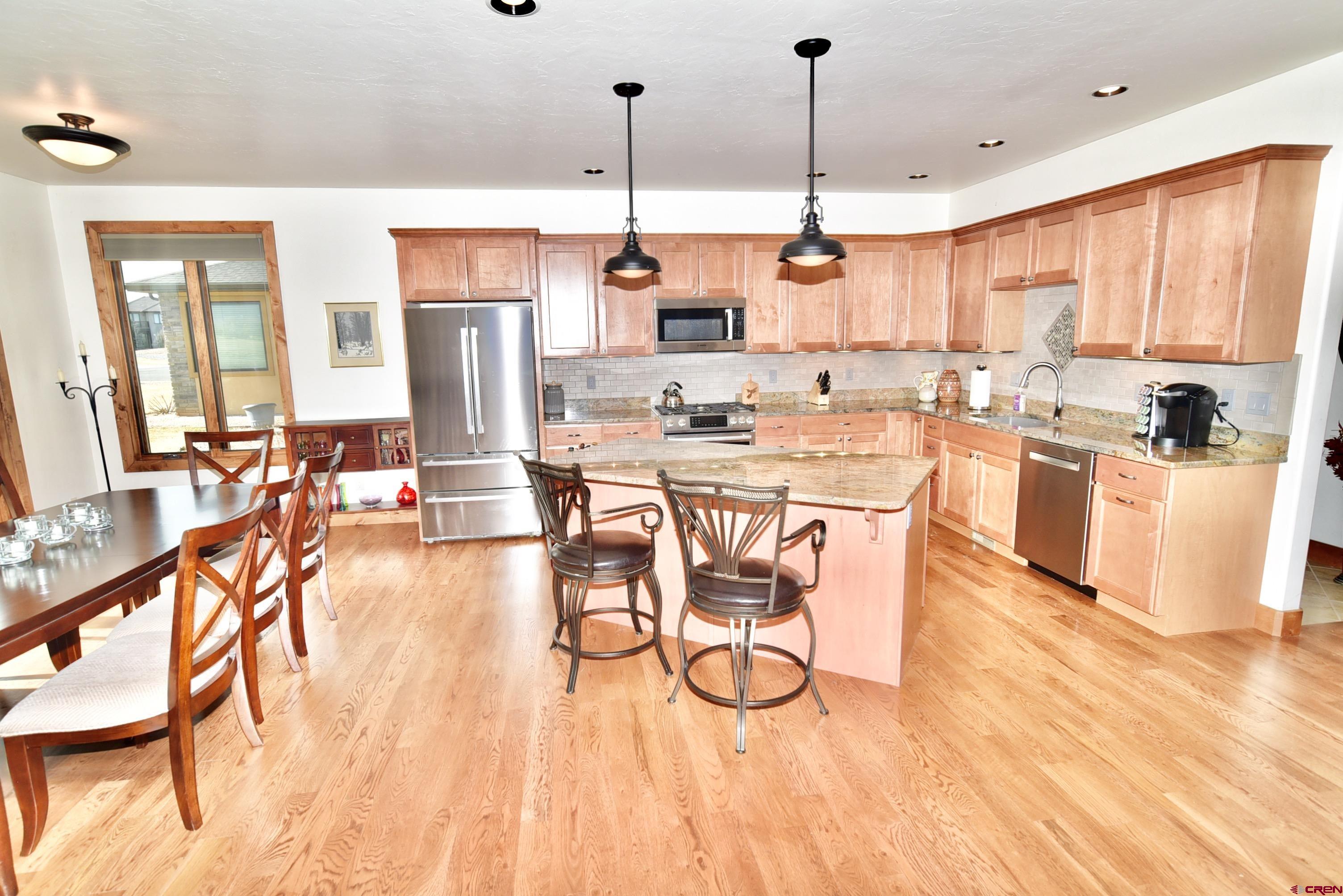 2136 Signature Ridge Lane Montrose, CO 81401 - Photo 12 of 32 a view of a kitchen and dining room