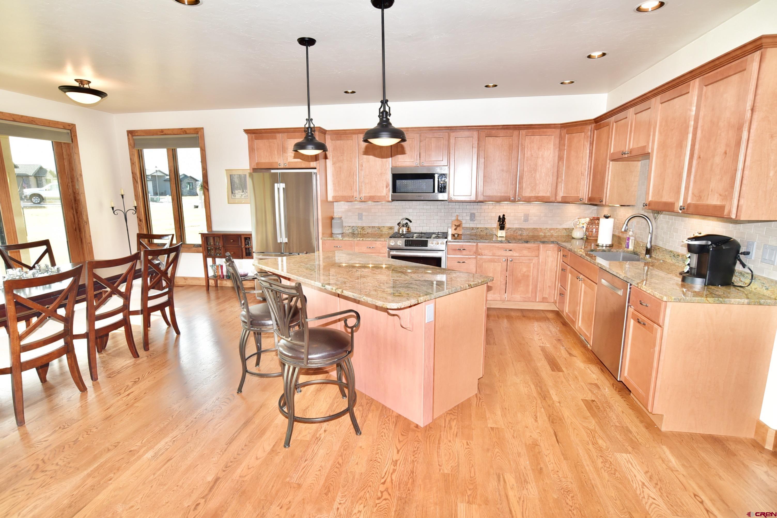 2136 Signature Ridge Lane Montrose, CO 81401 - Photo 13 of 32 a large kitchen with lots of counter space a sink and appliances