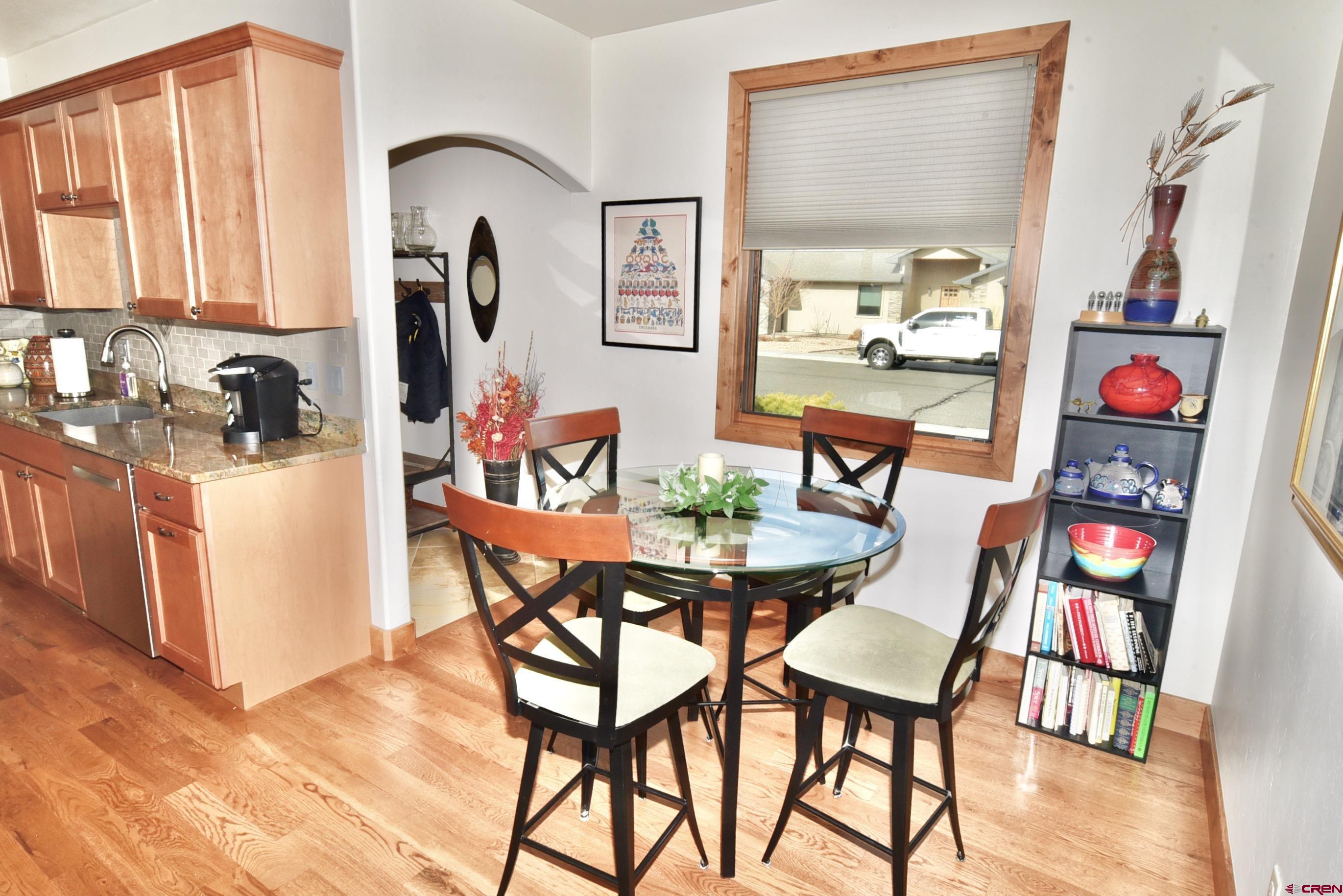 2136 Signature Ridge Lane Montrose, CO 81401 - Photo 16 of 32 a view of a dining room with furniture and a kitchen