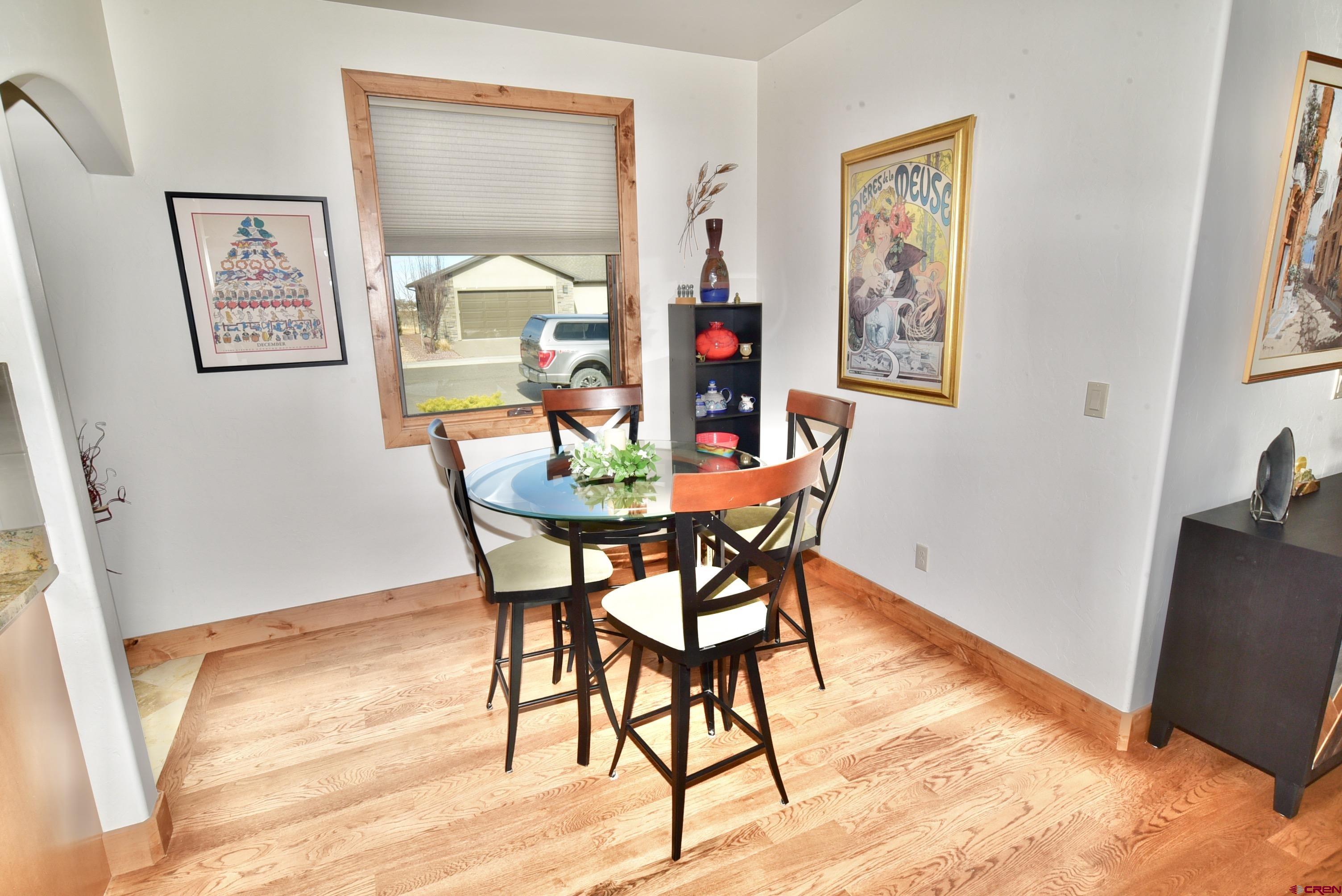 2136 Signature Ridge Lane Montrose, CO 81401 - Photo 17 of 32 a view of a dining room with furniture and wooden floor