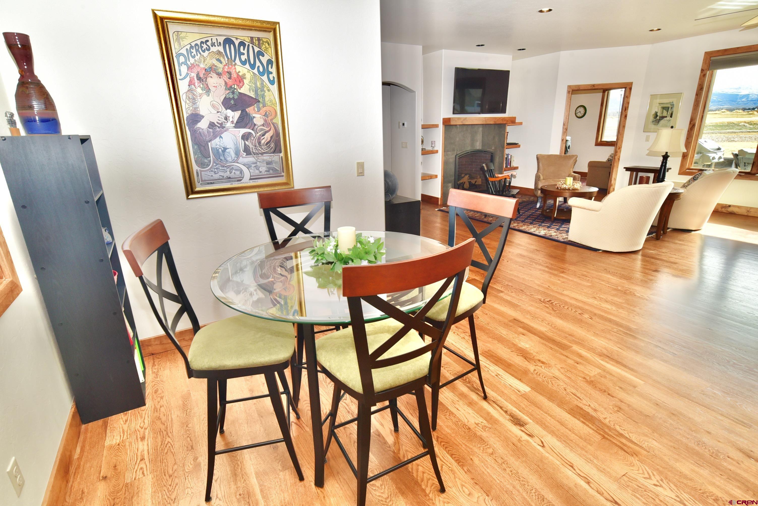 2136 Signature Ridge Lane Montrose, CO 81401 - Photo 18 of 32 a dining room with furniture and wooden floor