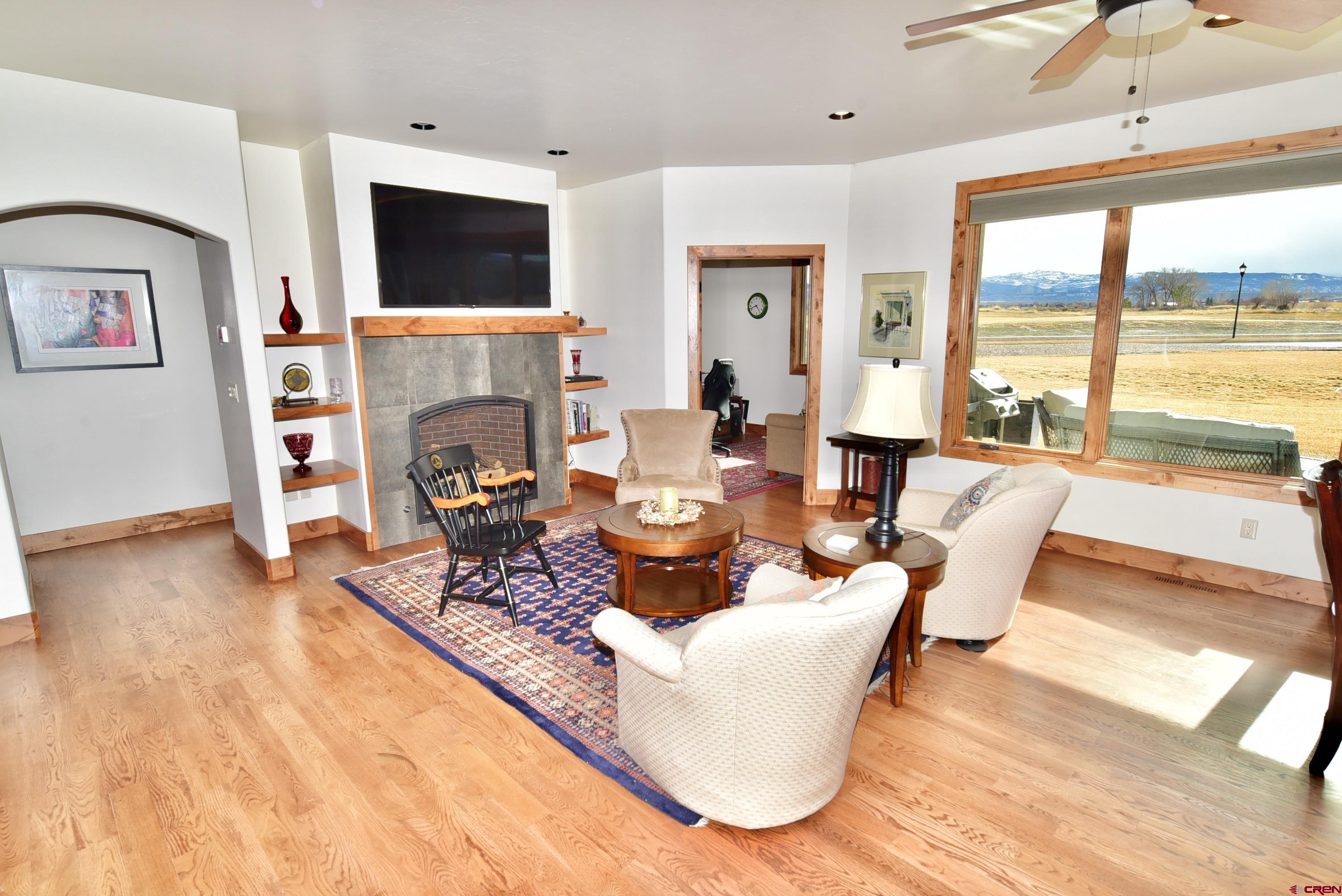 2136 Signature Ridge Lane Montrose, CO 81401 - Photo 20 of 32 a living room with fireplace furniture and a flat screen tv