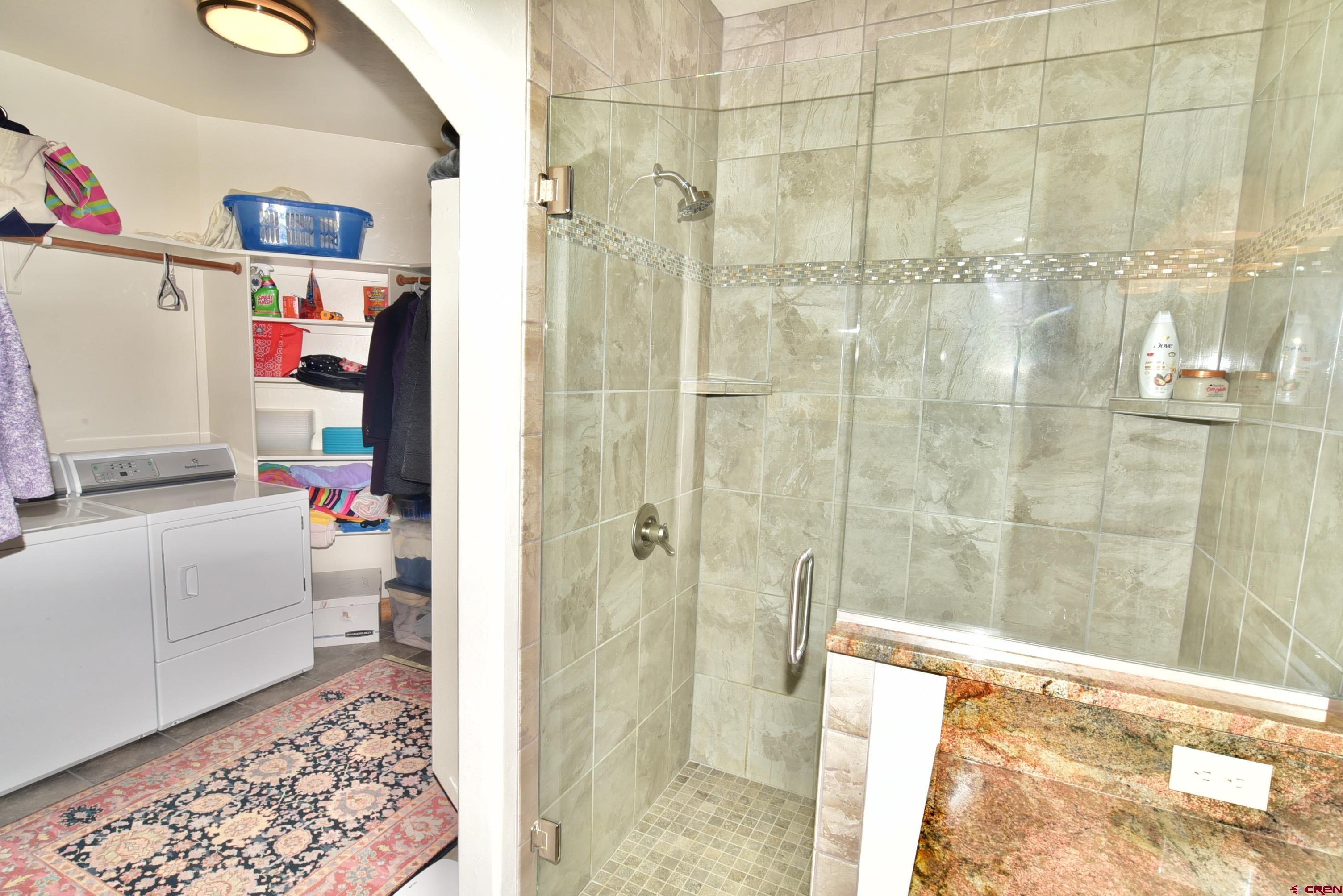 2136 Signature Ridge Lane Montrose, CO 81401 - Photo 25 of 32 a bathroom with a bathtub and shower