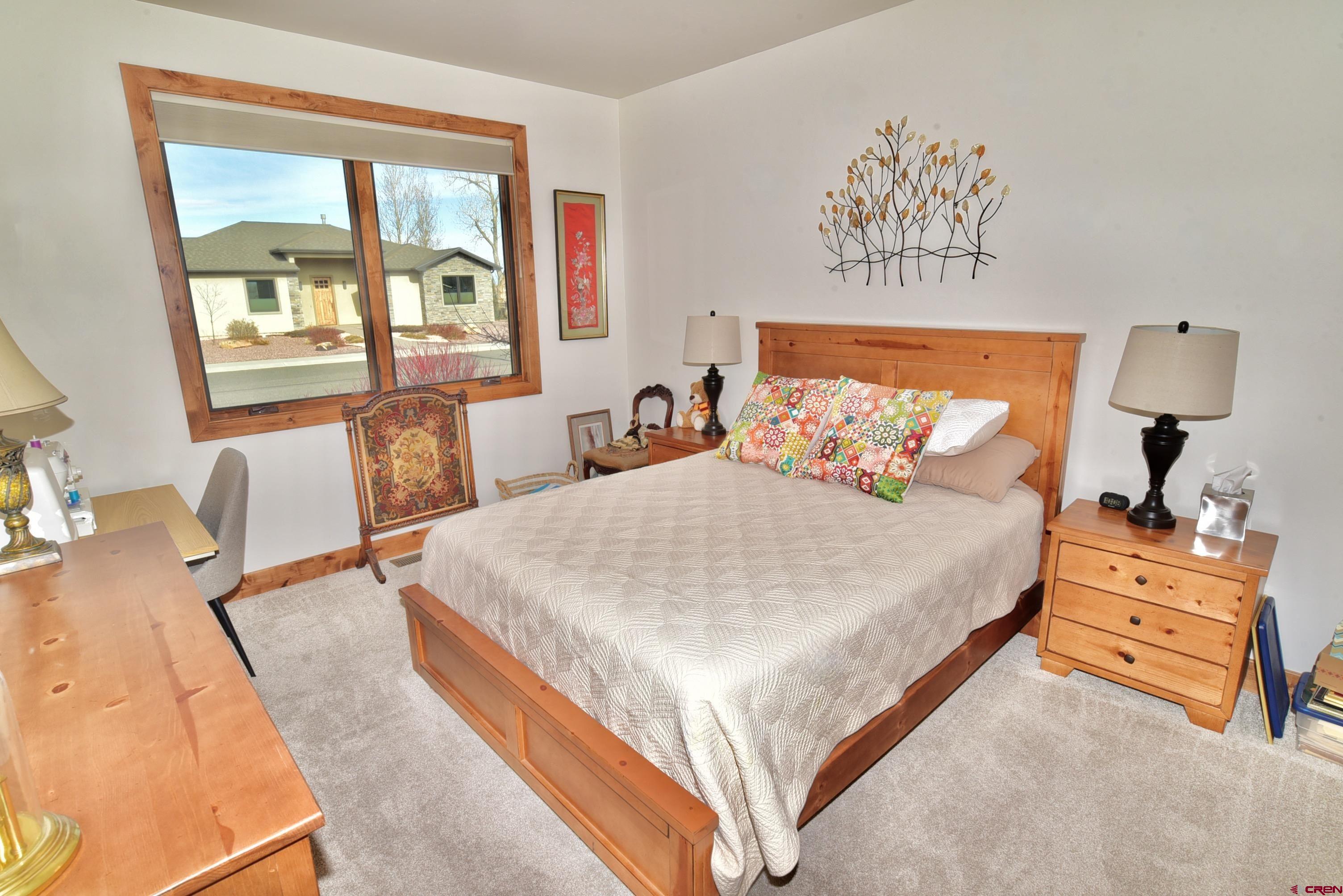 2136 Signature Ridge Lane Montrose, CO 81401 - Photo 28 of 32 a bedroom with a bed and window