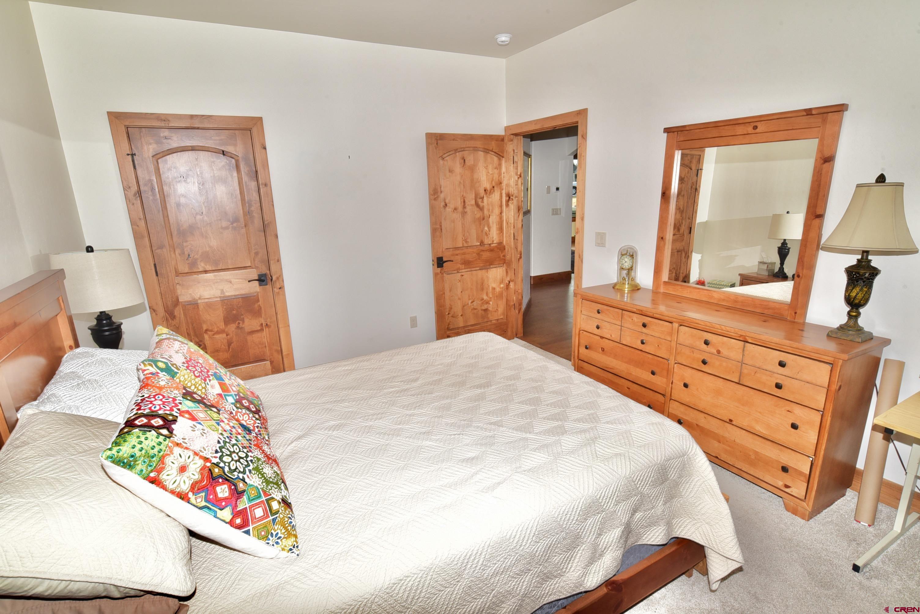 2136 Signature Ridge Lane Montrose, CO 81401 - Photo 29 of 32 a bedroom with a bed and a dresser