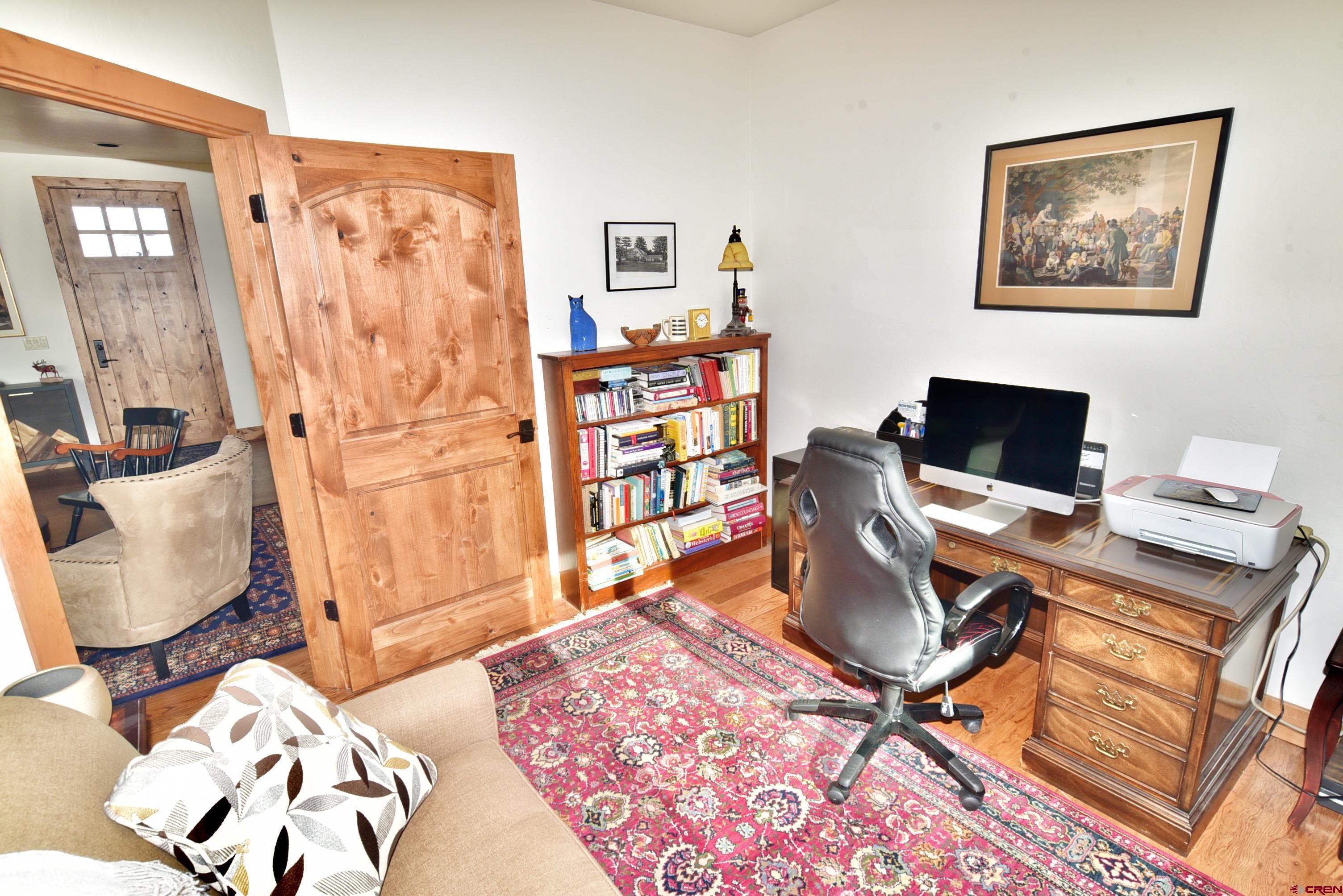 2136 Signature Ridge Lane Montrose, CO 81401 - Photo 30 of 32 a workspace with furniture and bookshelf