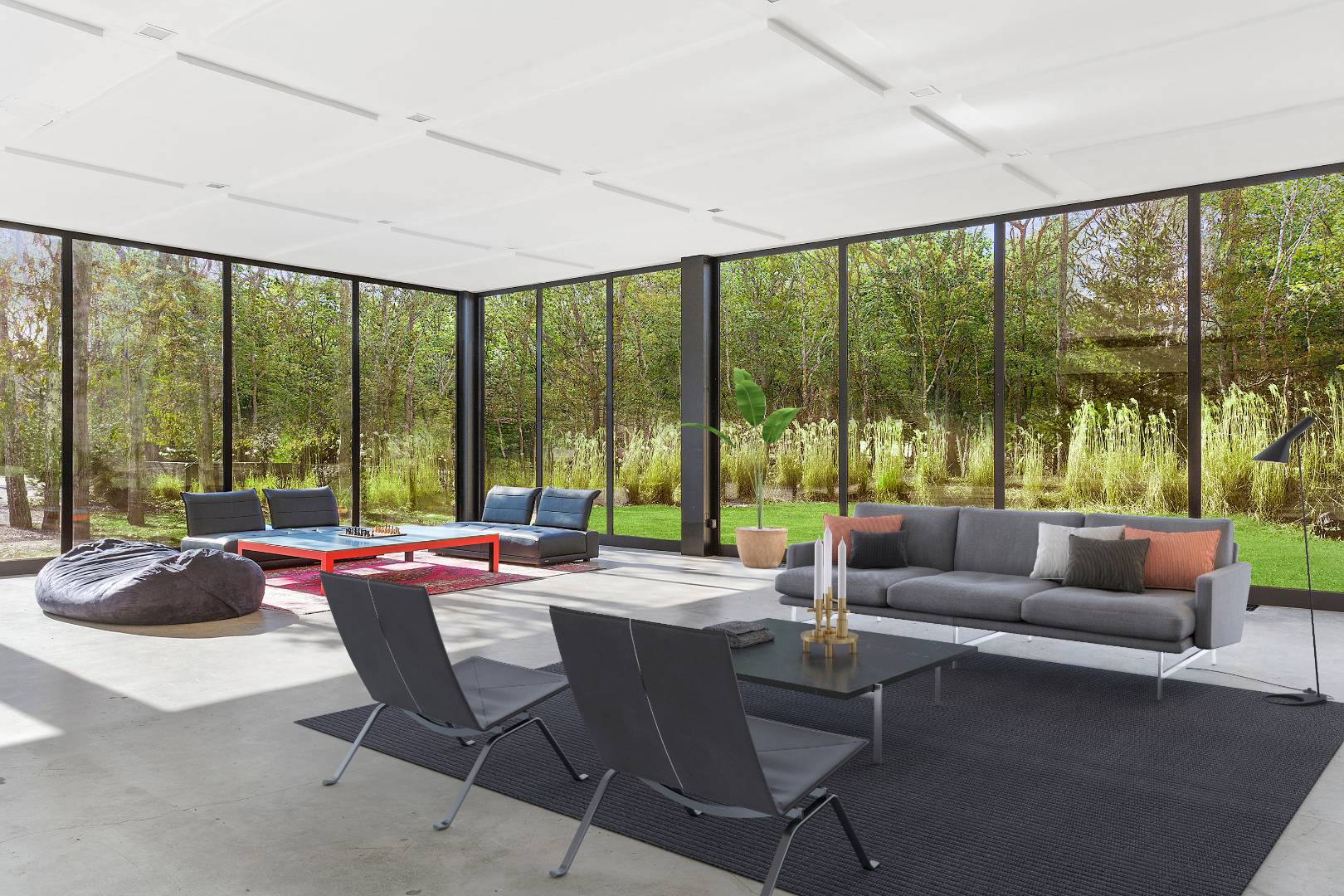 a living room with furniture and floor to ceiling windows