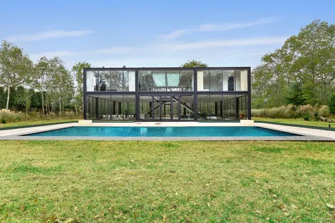 a view of swimming pool with palm trees
