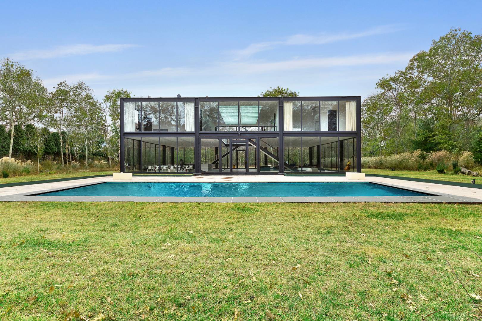 145 Neck Path East Hampton, NY 11937 - Photo 2 of 8 a view of swimming pool with palm trees