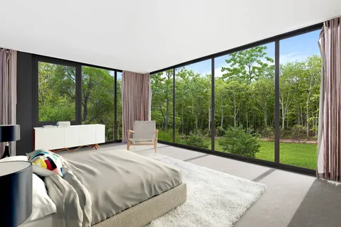 a bedroom with a bed and a large window