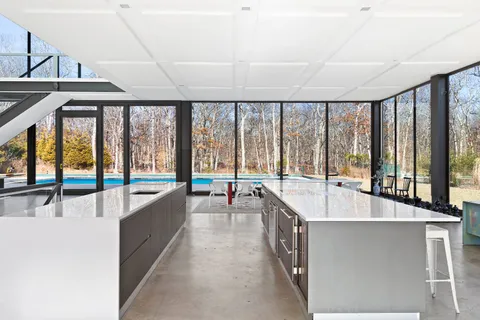 a living room with a large window and a table