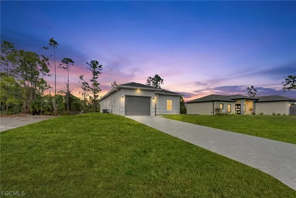 a yellow and red house with a yard