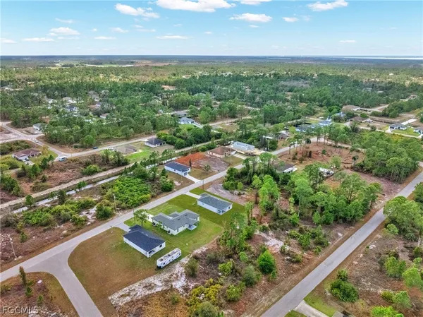 an aerial view of residential houses with outdoor space and street view