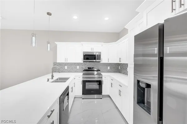 a kitchen with a sink stove and refrigerator