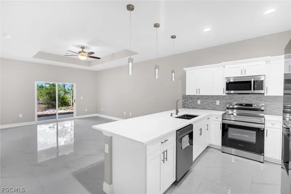 a kitchen with a stove sink and microwave