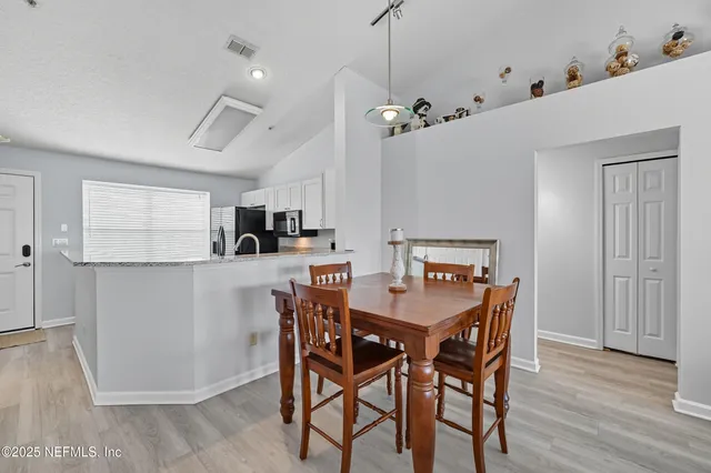 a view of a dining room with furniture and wooden floor