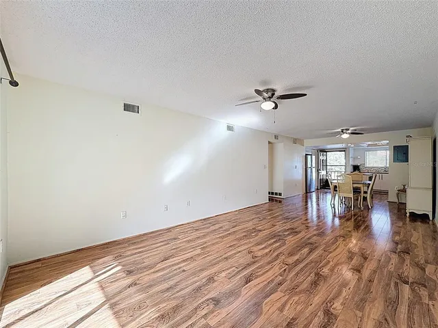 a view of a livingroom with furniture and a ceiling fan