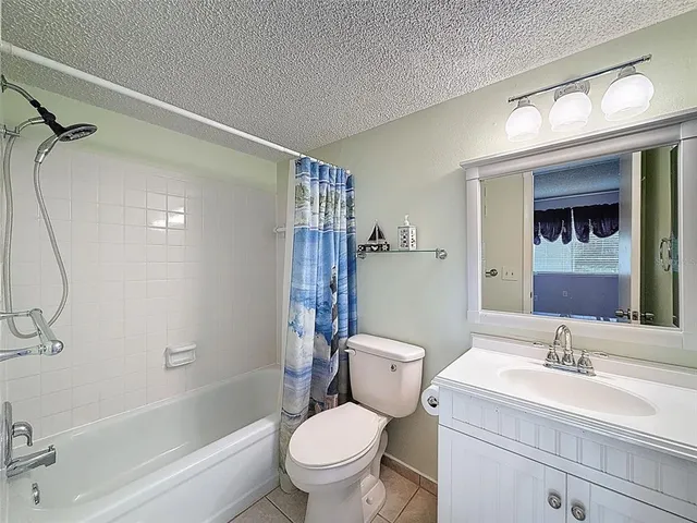 a bathroom with a sink toilet vanity and shower