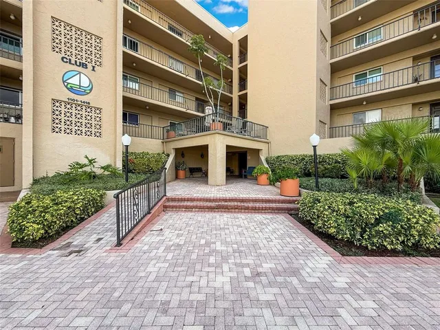 a front view of a building with garden