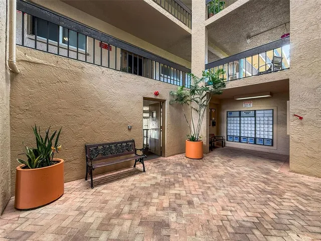 a view of a house with couches and potted plants