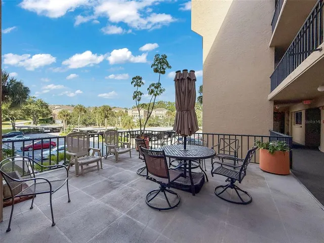 a view of a chairs and table in patio