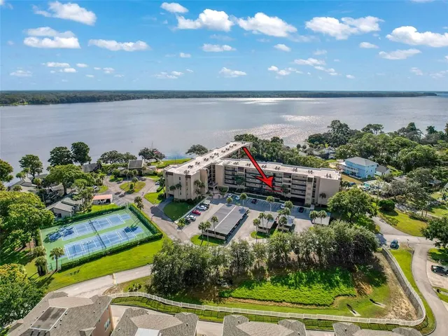 a view of a balcony with chairs and potted plants