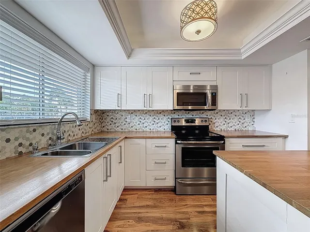 a kitchen with stainless steel appliances granite countertop a stove and a sink