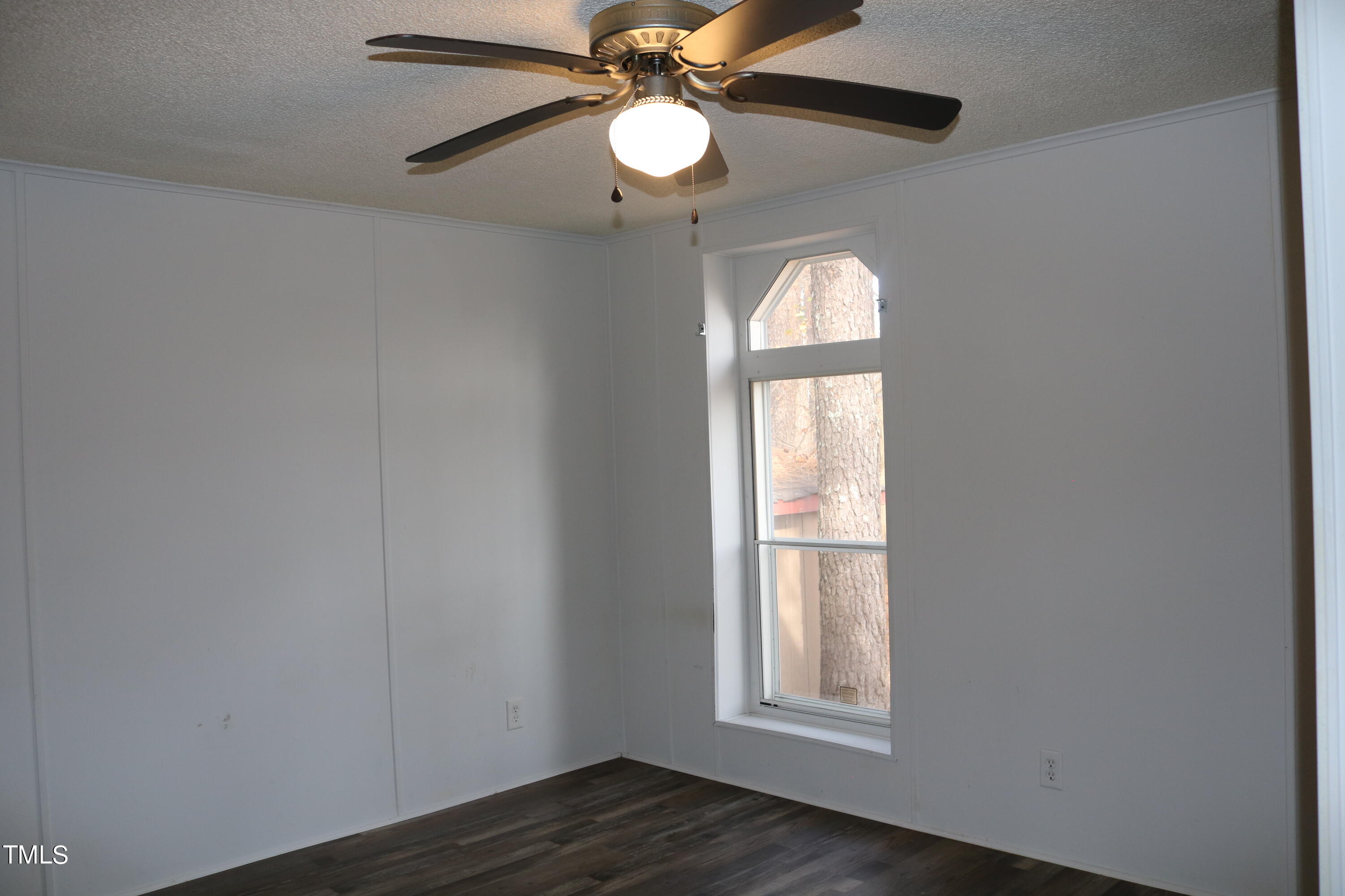 3537 Langston Road Raleigh, NC 27610 - Photo 17 of 21 a view of empty room with wooden floor and fan