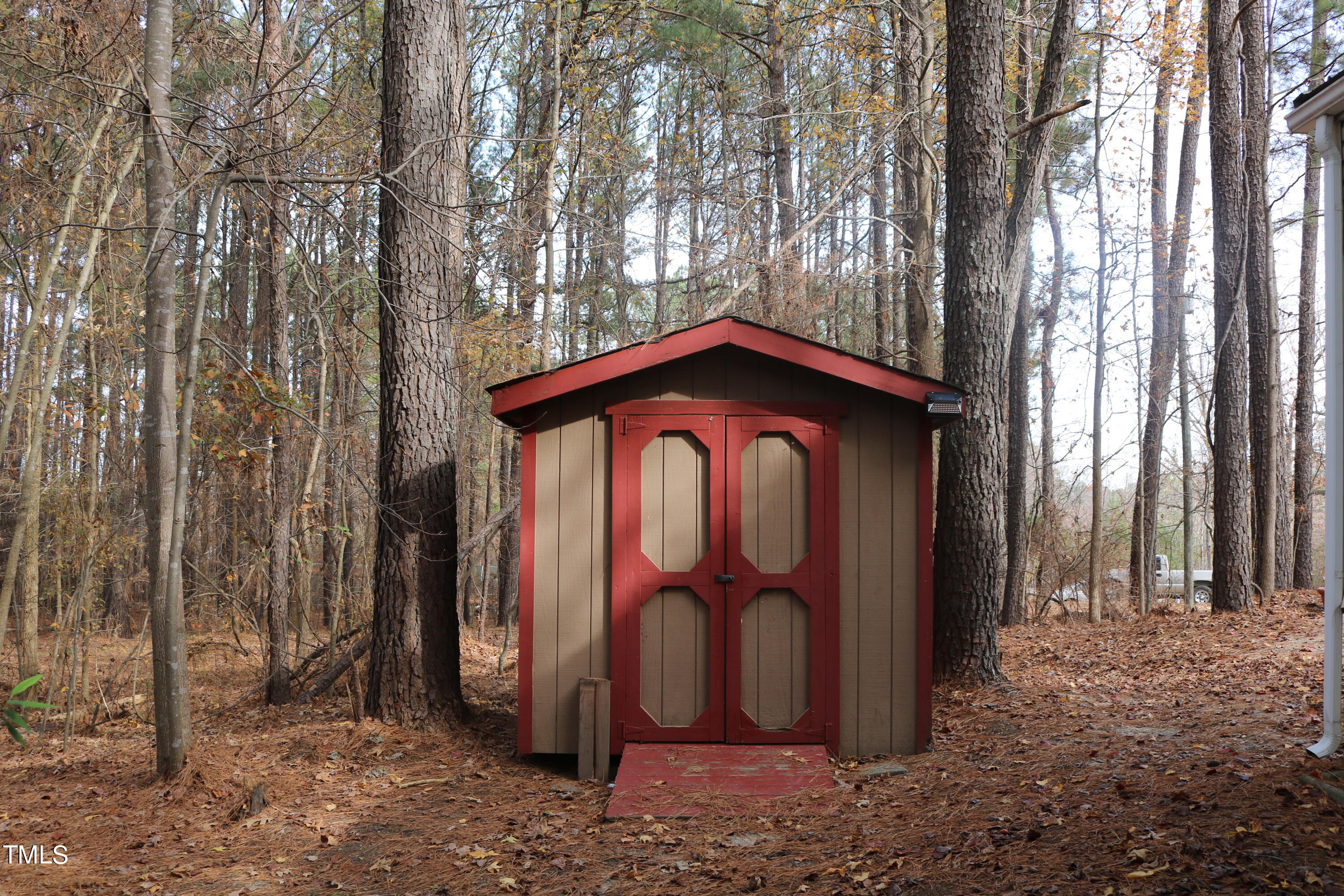 3537 Langston Road Raleigh, NC 27610 - Photo 20 of 21 a view of a barn with large trees and wooden fence