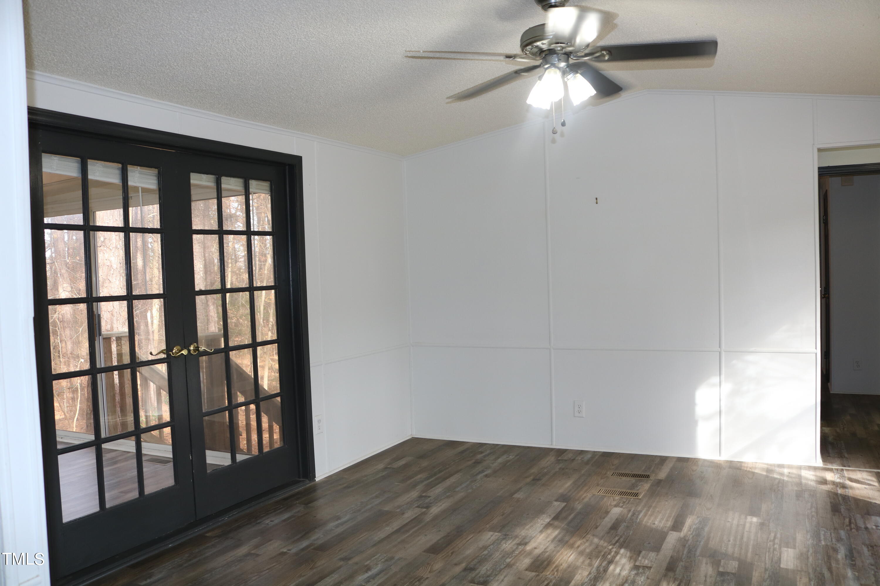 3537 Langston Road Raleigh, NC 27610 - Photo 3 of 21 a view of an empty room with window and chandelier fan
