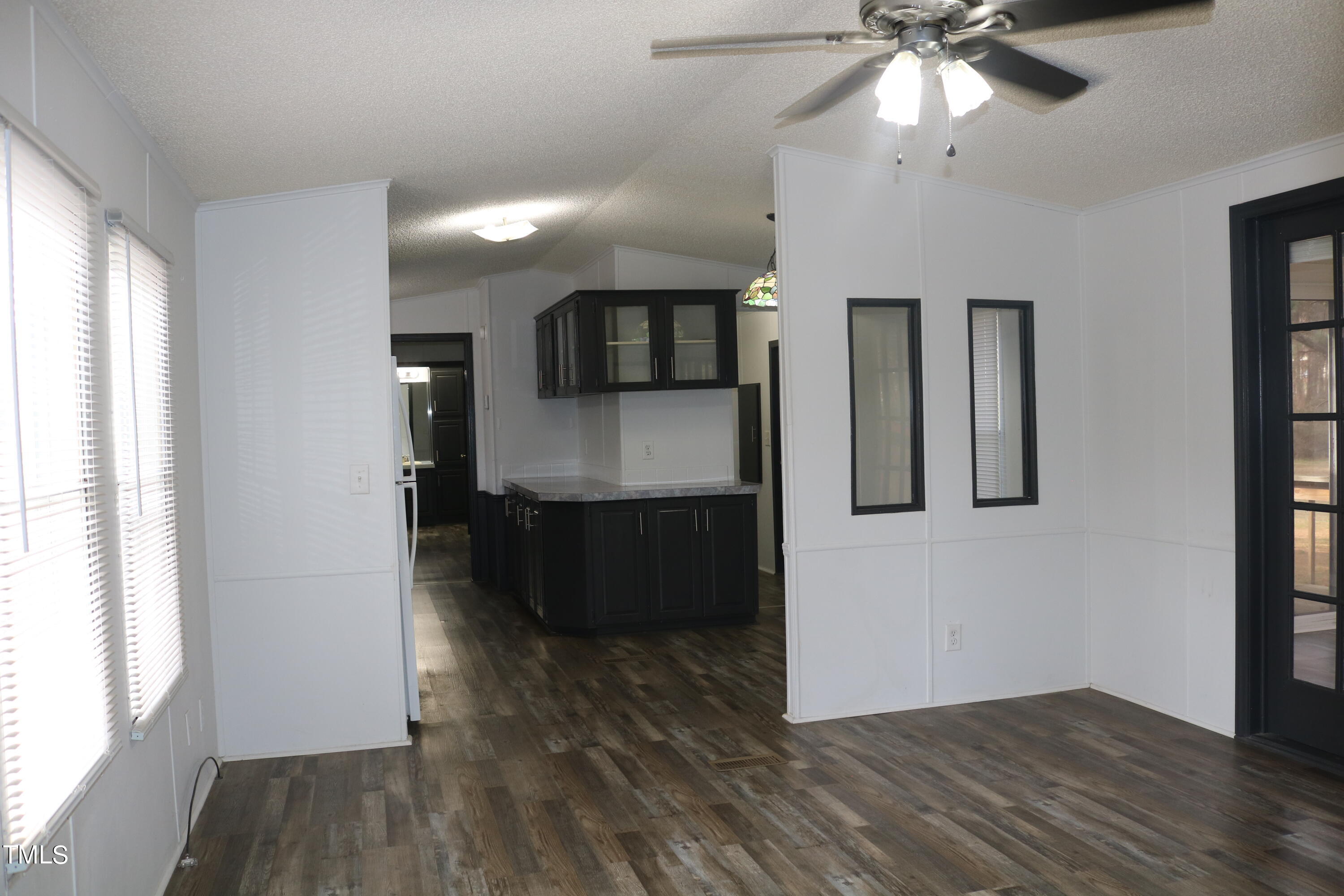 3537 Langston Road Raleigh, NC 27610 - Photo 4 of 21 a view interior of a house with wooden floor a ceiling fan and windows