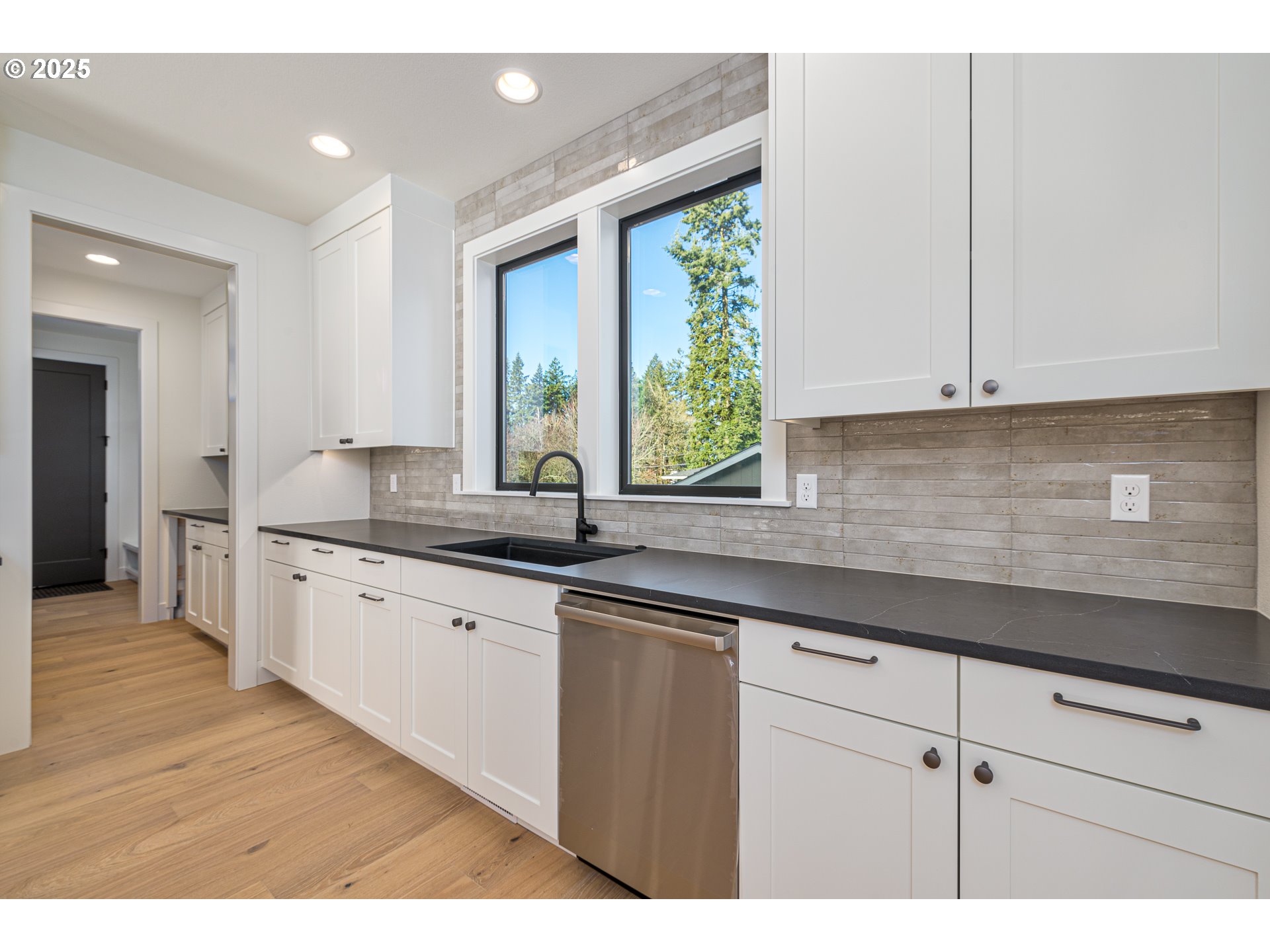 1855 Cloverleaf Road Lake Oswego, OR 97034 - Photo 11 of 34 a kitchen with granite countertop a sink and white cabinets