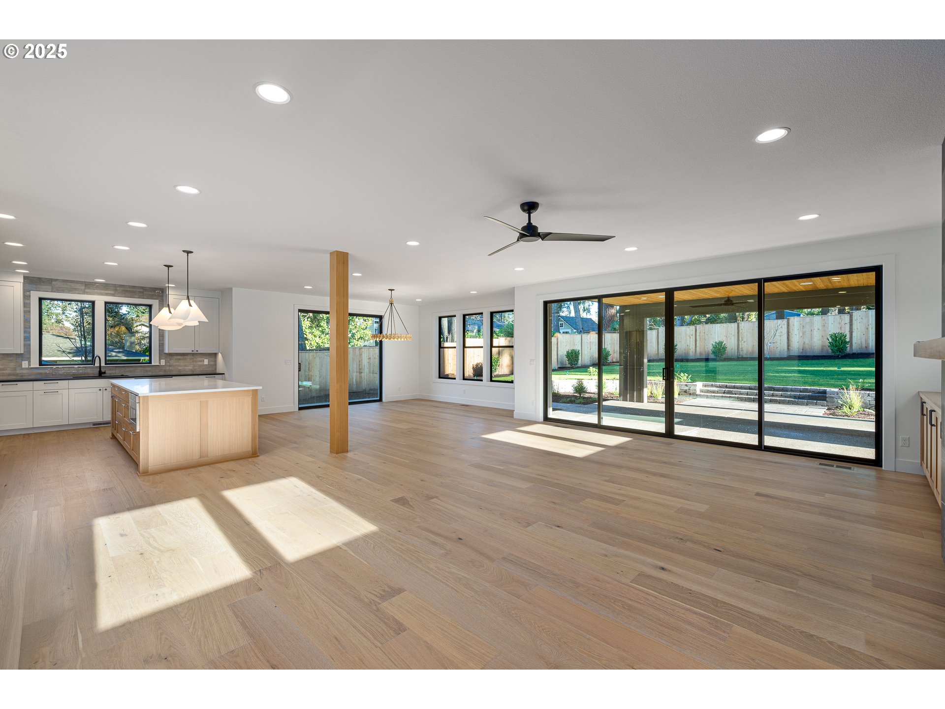 1855 Cloverleaf Road Lake Oswego, OR 97034 - Photo 6 of 34 a view of an empty room with wooden floor and a window
