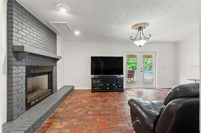 a view of a patio with a table chairs and a backyard