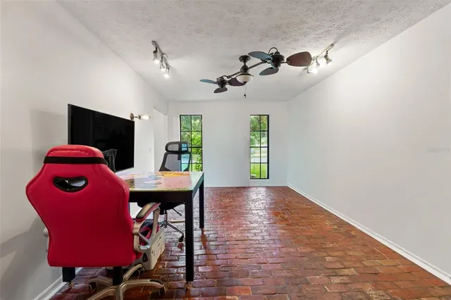 a front view of a house with swimming pool and furniture