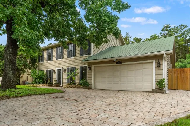 a front view of a house with a garden and garage