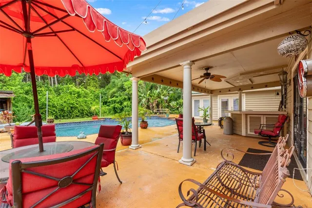 a en suite bathroom with a granite countertop sink and a mirror