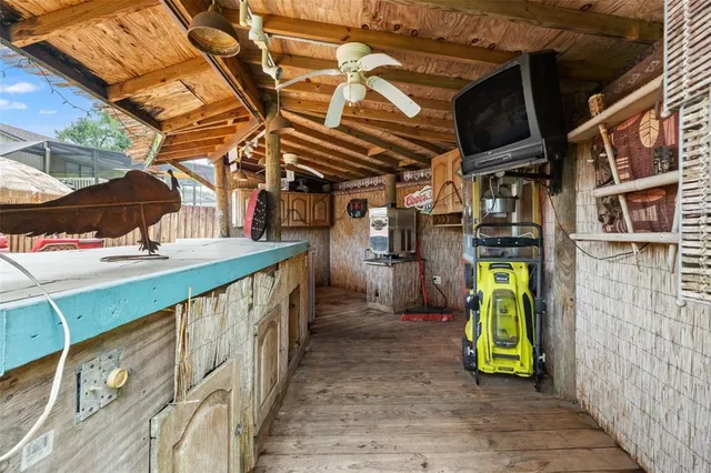 a view of a brick house with large windows and a yard