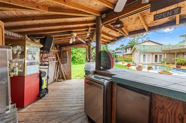 a view of a patio with a table and chairs under an umbrella