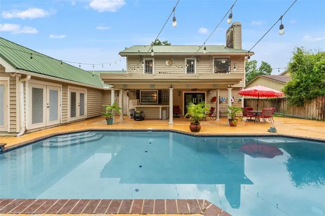 a view of swimming pool with chairs in patio