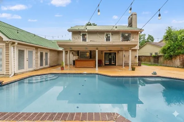 a view of a white house with swimming pool